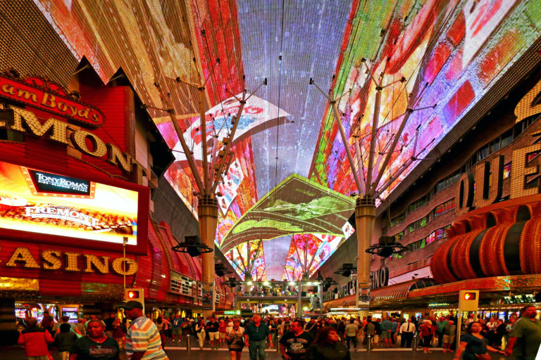 The Freemont Street Experience, Las Vegas: a pedestrian mall surrounded by lights and screens in an array of different colours.