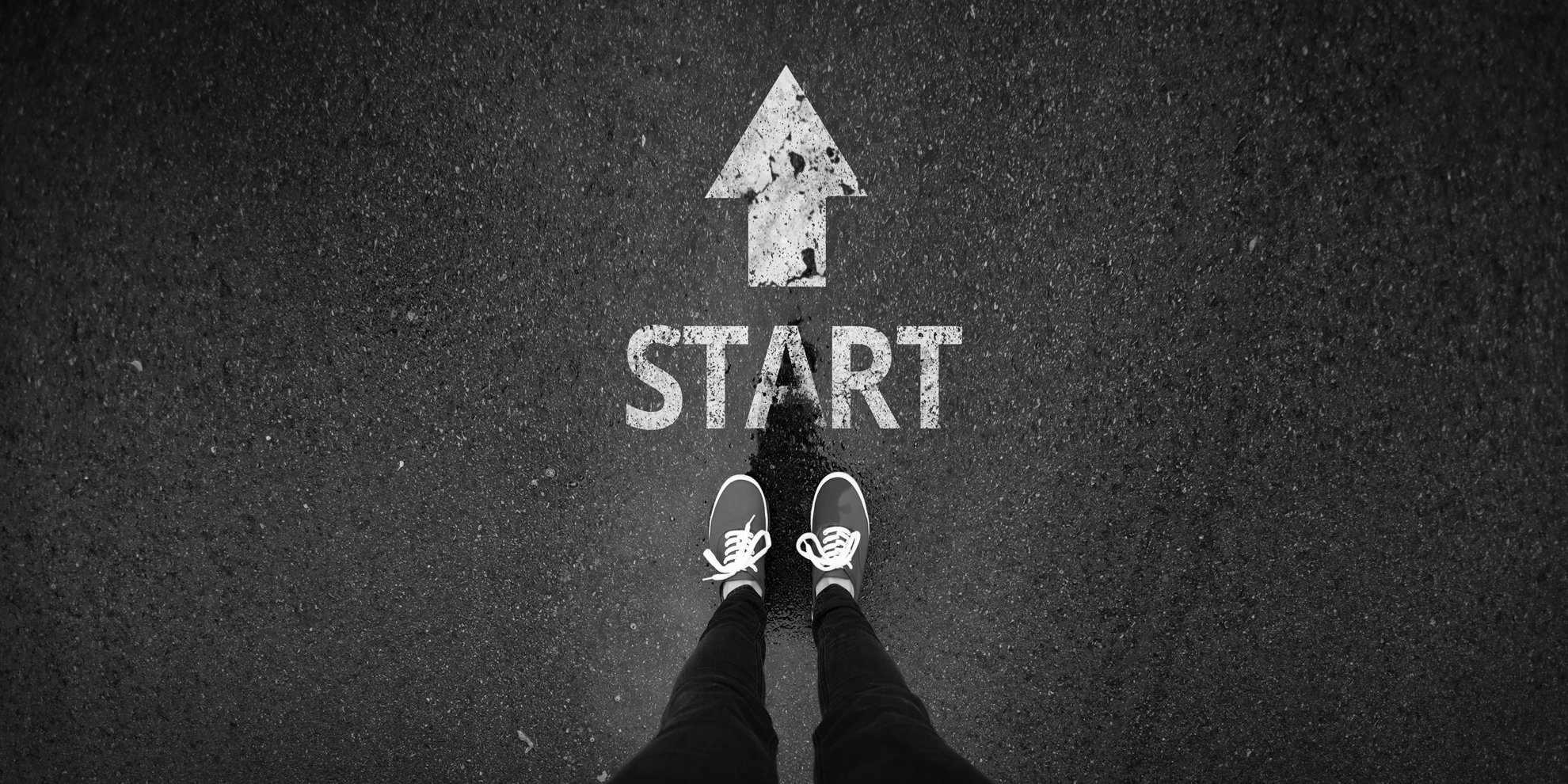 a photo of feet near a start sign on the ground