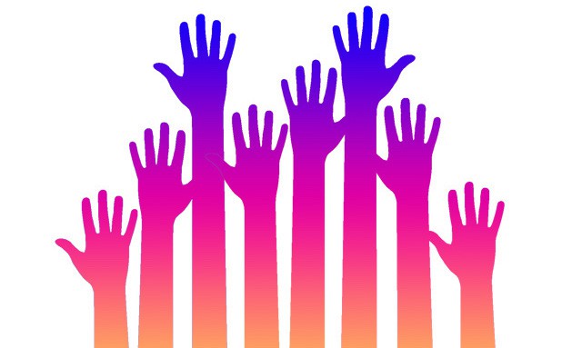 Raised hands, representing this year's International Women's Day theme of #PledgeforParity