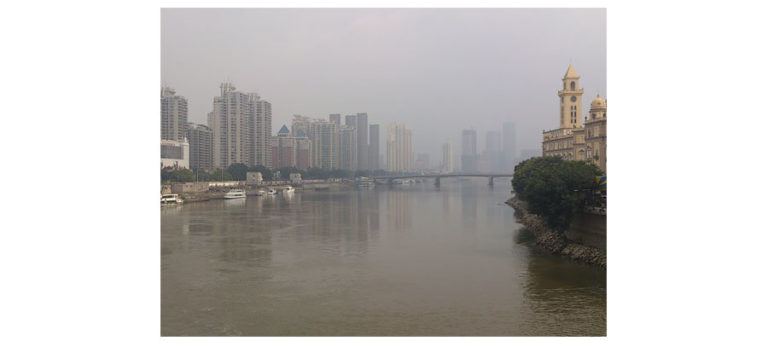 Morden city beside a river with tall buildlings