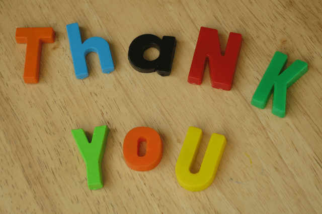 Letters on a table spell out "Thank you" 