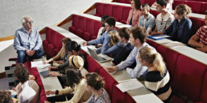 University students prepare to watch lecture in a lecture theatre