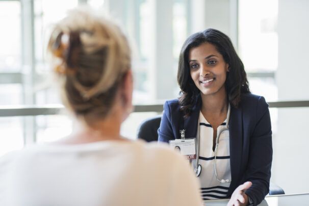 Doctor talking with patient in office
