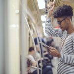 man on train using digital tablet
