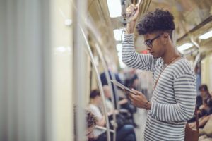 man on train using digital tablet