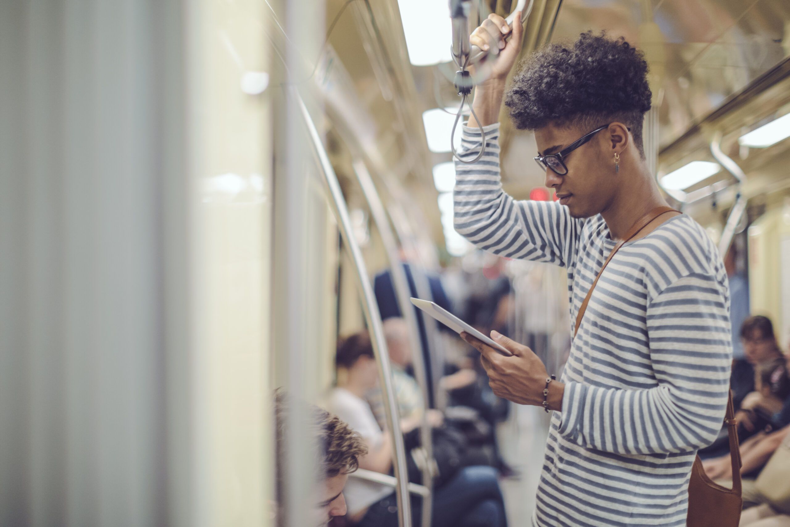 man on train using digital tablet