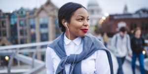 Woman with high self-esteem smiles and listens to music