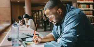 Man works on creating an online course at his desk