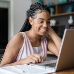 Teen learns online at home on her laptop