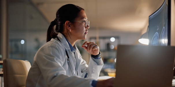 woman working on laptop in hospital at night