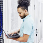 Microsoft Azure tech engineer configures programme using a laptop computer