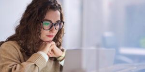 woman looking at laptop screen