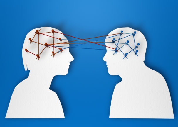Two Paper Heads Showing Brain Connection Threads Between